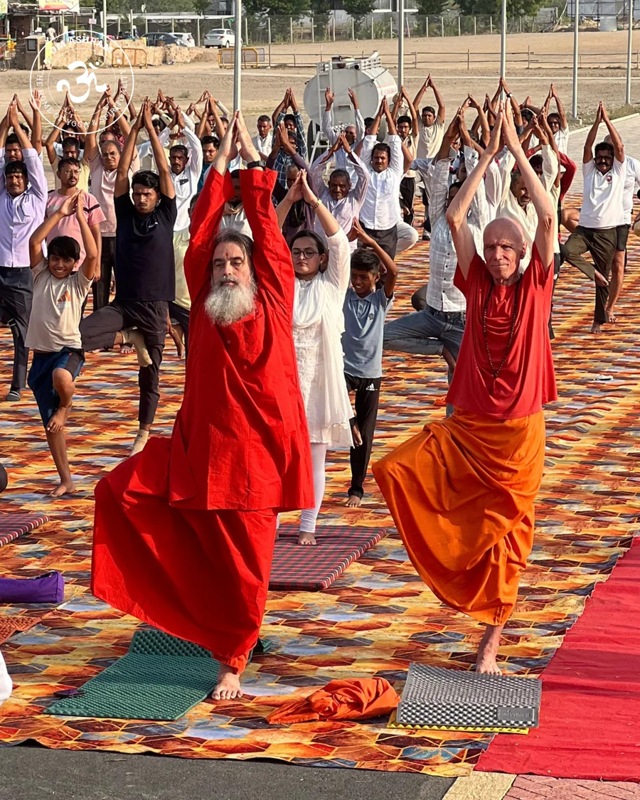 Practitioners performing a one-legged balancing yoga pose for concentration.